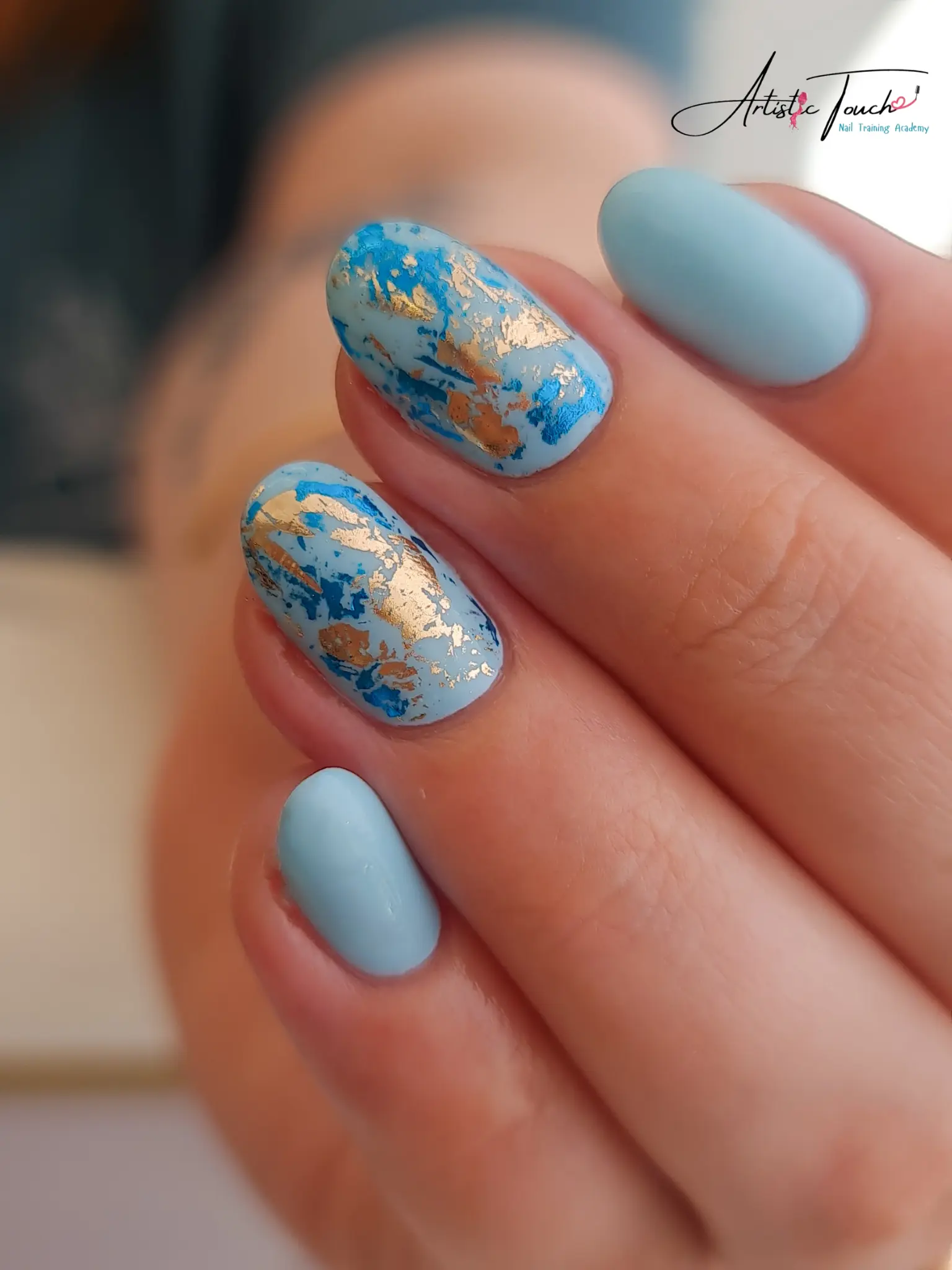 Creative blue and gold nail art over BIAB base showing versatility and durability of Builder in a Bottle