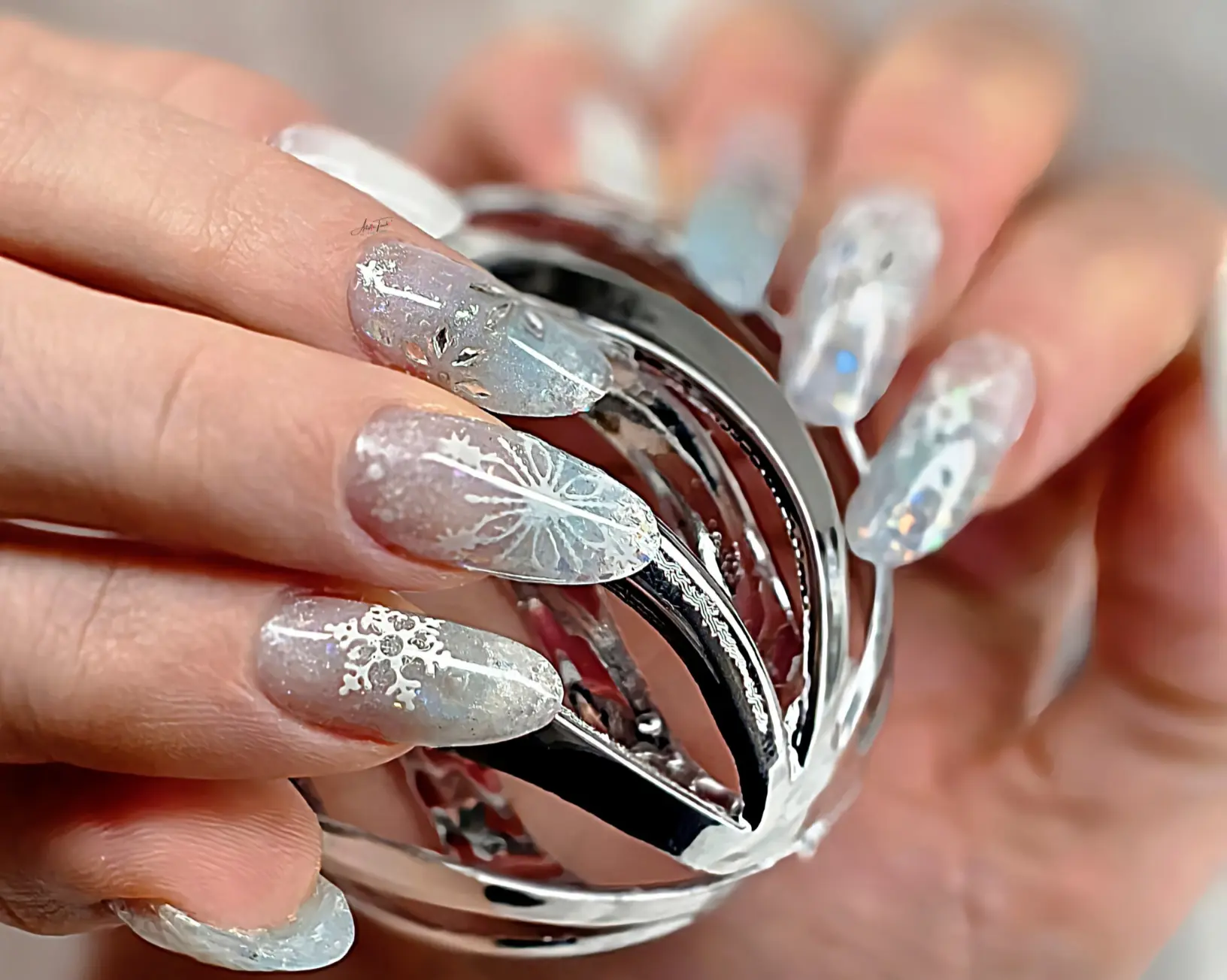 Professional frosty snowflake nails created using sandwich dual forms technique with 3D snowflake embellishments and chrome ombre effect