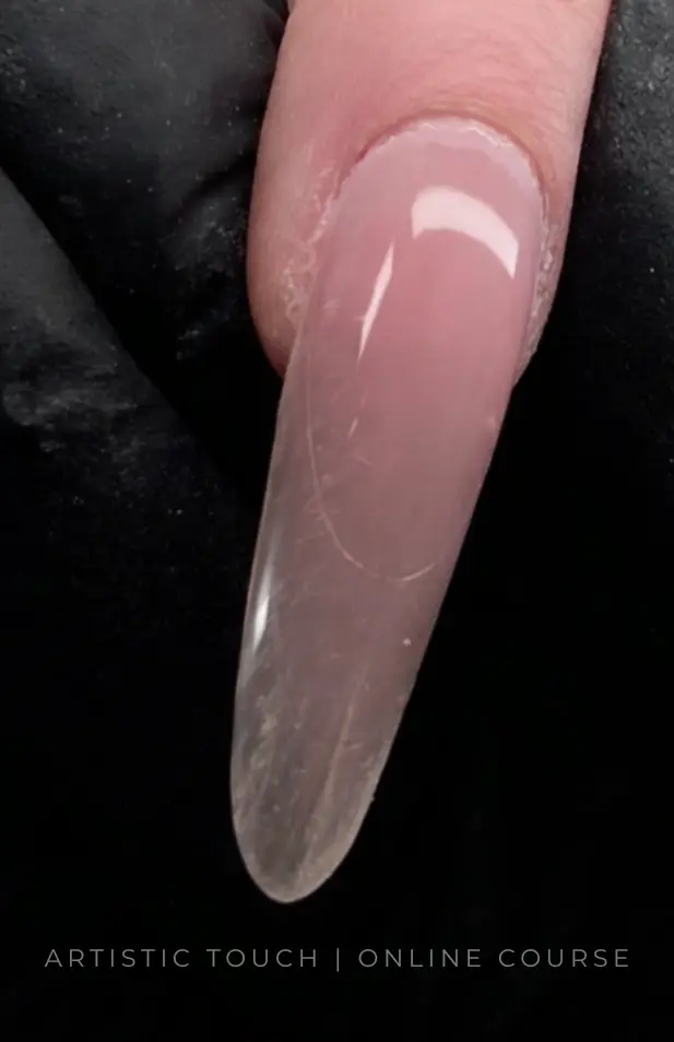 Finished almond nail created using sandwich dual forms system showing balanced structure