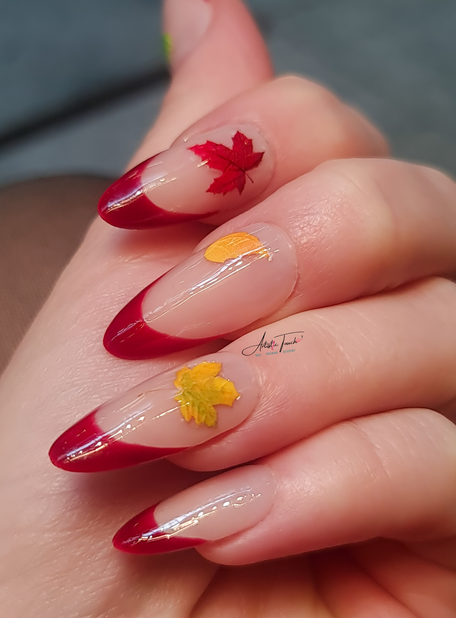 Red French manicure with autumn leaf nail art created by Radina Ignatova